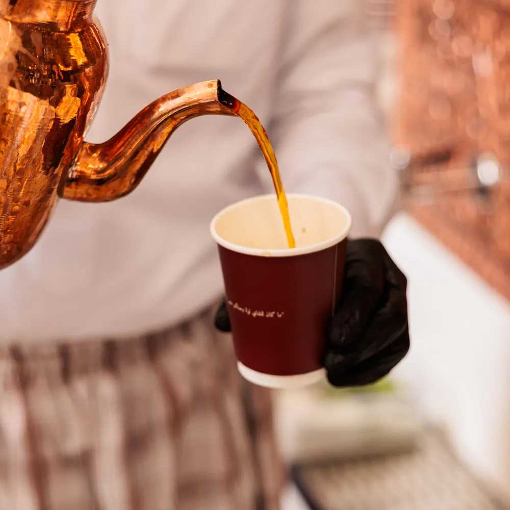 Tea poured from a copper kettle at Ghancha Café